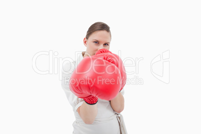 Young businesswoman boxing