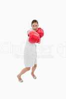 Portrait of a businesswoman punching someone