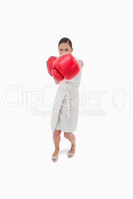 Portrait of a serious businesswoman punching someone