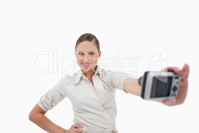 Young businesswoman taking a picture of herself
