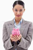 Portrait of a businesswoman holding a piggy bank