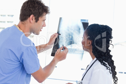 Happy doctors looking at a of X-ray