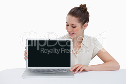 Young businesswoman showing a laptop