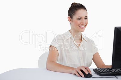 Smiling businesswoman using a monitor