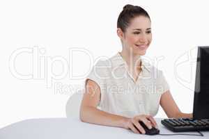 Smiling businesswoman using a monitor