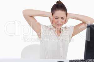 Exhausted businesswoman having a headache while using a computer