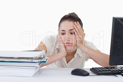 Sad businesswoman leaning on her desk