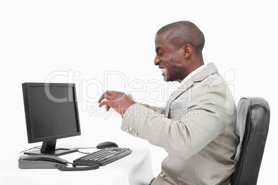 Angry businessman using a monitor