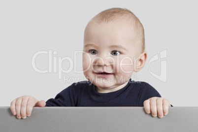 young child holding sign