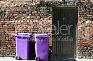 Rufuse bins against old brick wall