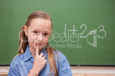 Smiling schoolgirl thinking