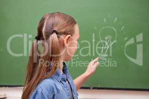 Schoolgirl pointing at a bulb