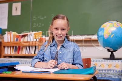 Cute schoolgirl doing classwork