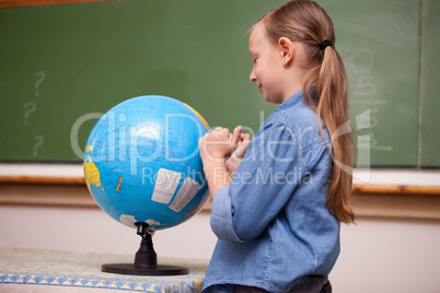 Schoolgirl looking at a globe