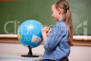 Schoolgirl looking at a globe