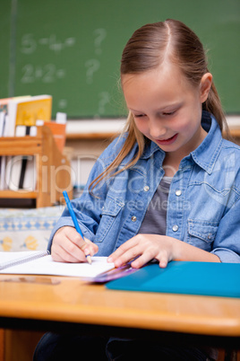 Portrait of a schoolgirl writing
