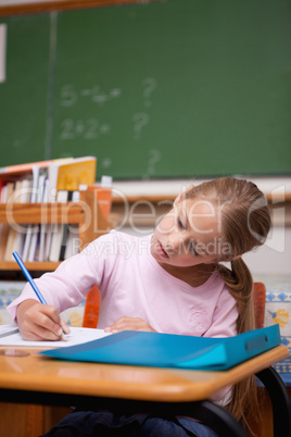 Portrait of a focused schoolgirl writing