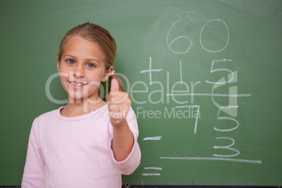 Cute schoolgirl with the thumb up