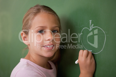 Schoolgirl drawing an apple
