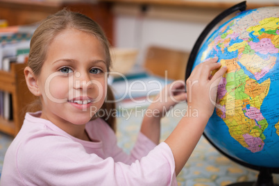 Schoolgirl pointing at a country