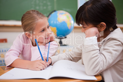 Cute schoolgirls doing classwork