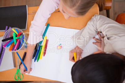 Above view of schoolgirls drawing