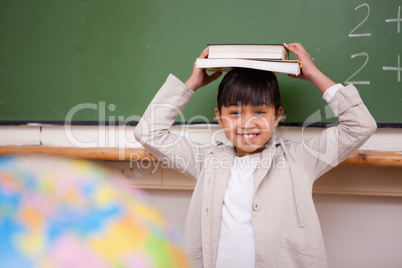 Schoolgirl holding her book on her head