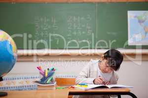 Schoolgirl drawing on a coloring book