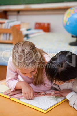 Portrait of focused schoolgirls reading a fairy tale