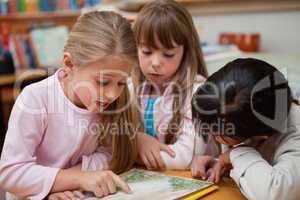 Schoolgirls reading a fairy tale together