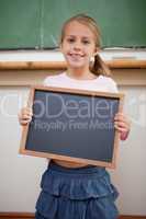 Portrait of a happy girl holding at a school slate