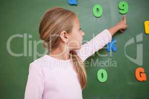 Schoolgirl pointing at a number