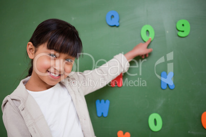 Schoolgirl pointing at a letter