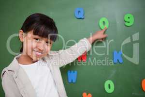 Schoolgirl pointing at a letter