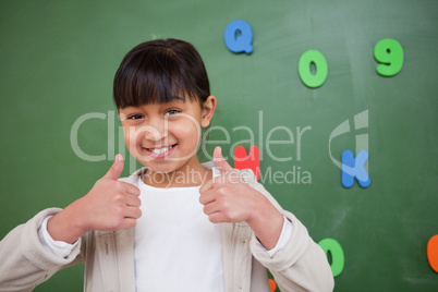 Happy schoolgirl with the thumbs up
