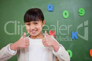 Happy schoolgirl with the thumbs up