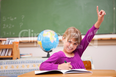 Schoolgirl raising her hand to ask a question