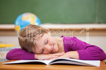 Schoolgirl sleeping on her desk