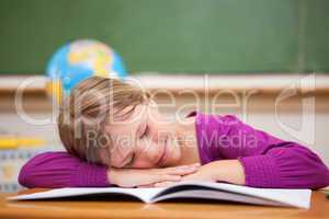 Schoolgirl sleeping on her desk