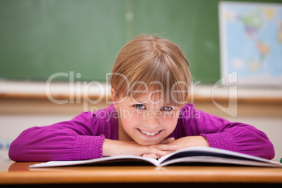 Schoolgirl leaning on a desk