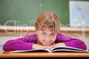 Schoolgirl leaning on a desk