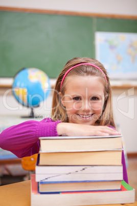 Portrait of schoolgirl posing with books