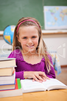 Portrait of young schoolgirl reading a book