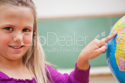 Close up of a schoolgirl pointing at a country