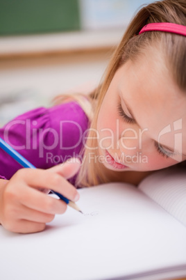 Portrait of a young schoolgirl writing