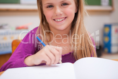 Close up of a young schoolgirl writing