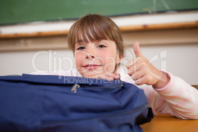 Schoolgirl posing with a bag and the thumb up
