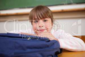 Cute schoolgirl posing with a bag