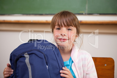 Happy schoolgirl posing with a bag