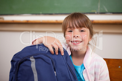 Smiling schoolgirl posing with a bag
